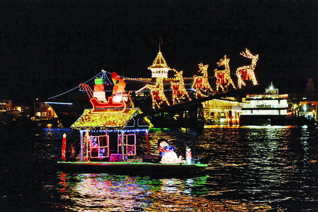 Reindeers and bright twinkling lights adorn a boat participating in the Newport Beach Christmas Boat Parade