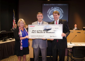 BAE Systems San Diego Ship Repair Vice President and General Manager Bob Koerber present a $300,000 check to Port of San Diego CEO Randa Coniglio and Port Chairman Marshall Merrifield.Port of San Diego photo